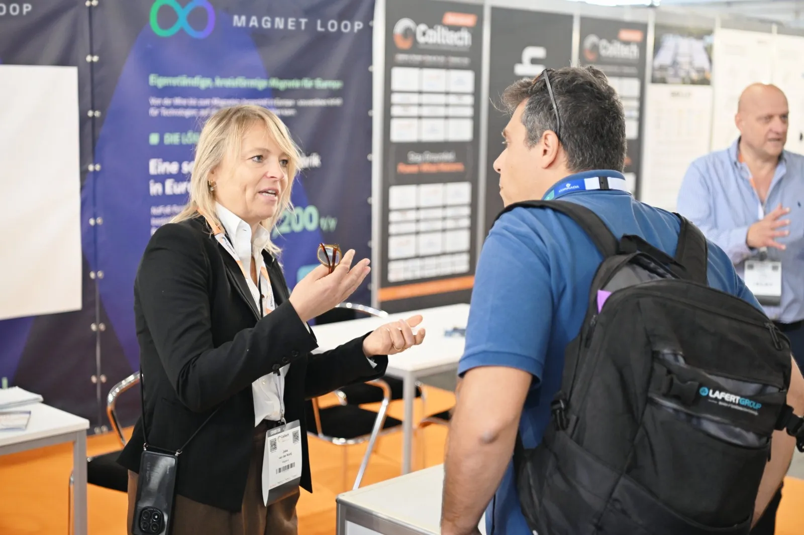 In conversation with a visitor at the Magnet Loop stand